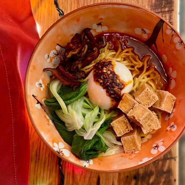 Old Thousand's Chinese noodle bowl with bok choy, fried tofu, mushrooms, and a soft-boiled egg.
